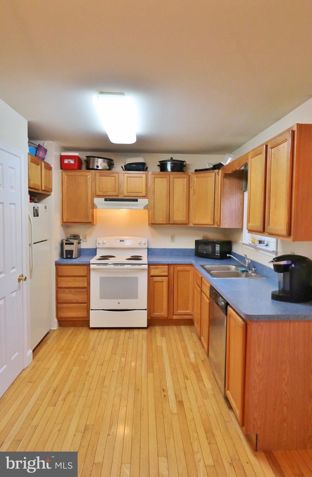 5924 Hillside Road St. Leonard, MD 20685 - Photo 5 of 24 a large kitchen with granite countertop a large counter top space a sink and appliances