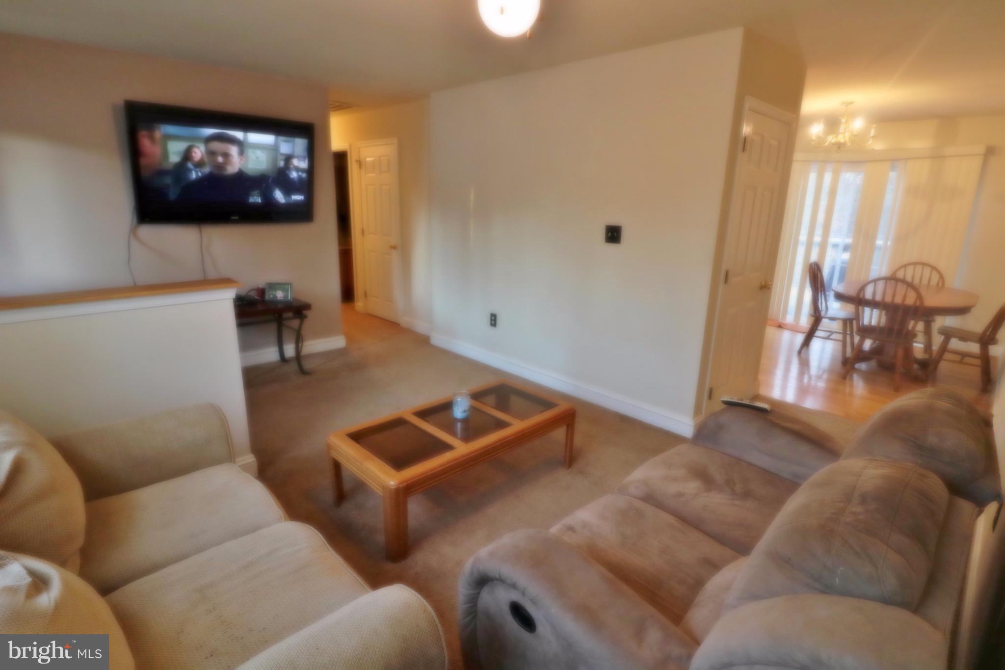 5924 Hillside Road St. Leonard, MD 20685 - Photo 6 of 24 a living room with furniture and a flat screen tv