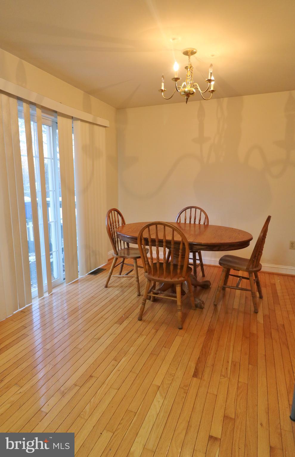 5924 Hillside Road St. Leonard, MD 20685 - Photo 7 of 24 a view of a dining room with furniture and wooden floor