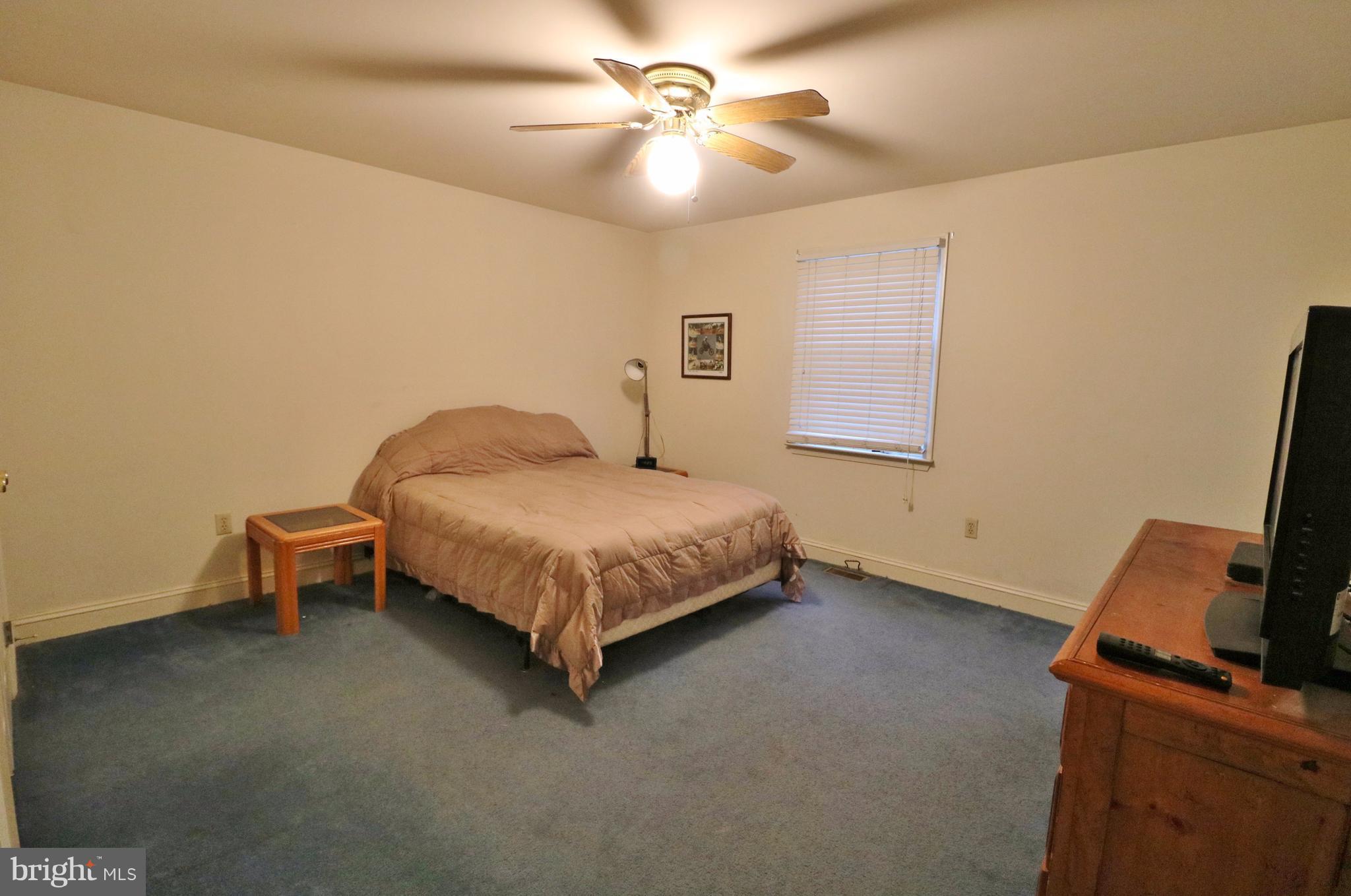 5924 Hillside Road St. Leonard, MD 20685 - Photo 8 of 24 a bedroom with a bed and a ceiling fan