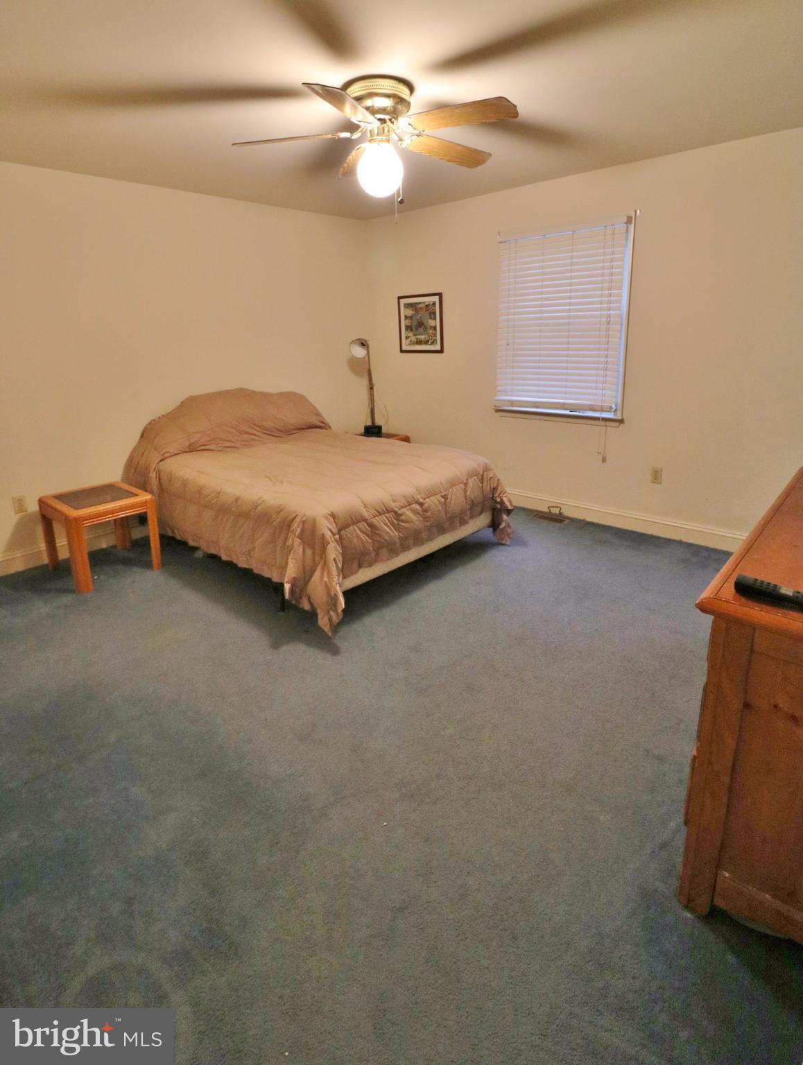 5924 Hillside Road St. Leonard, MD 20685 - Photo 9 of 24 a bedroom with a bed and a chandelier