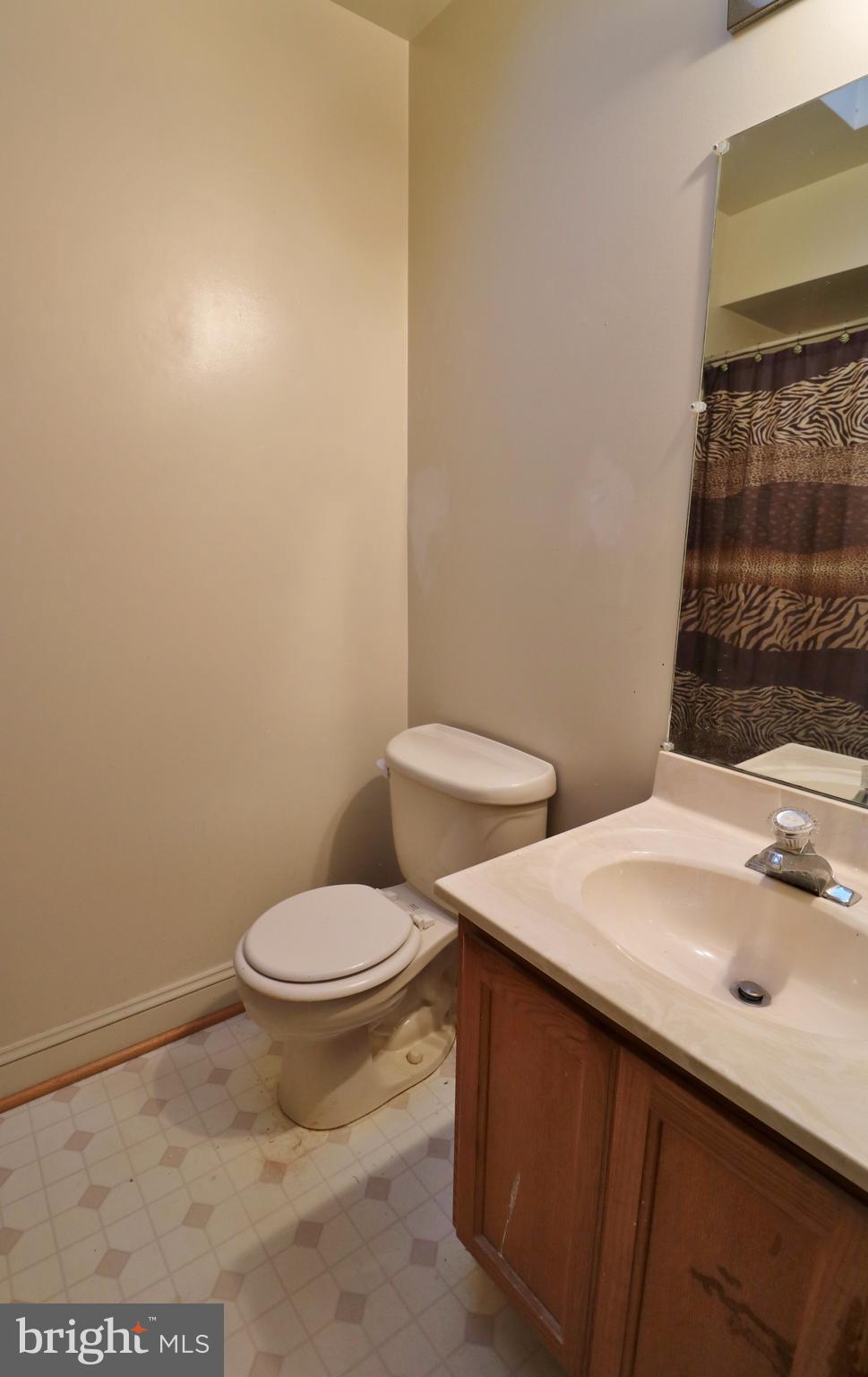 5924 Hillside Road St. Leonard, MD 20685 - Photo 10 of 24 a white toilet sitting next to a bathroom sink