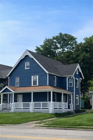 a front view of a house with a garden