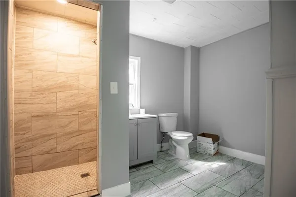 a bathroom with a toilet and a shower