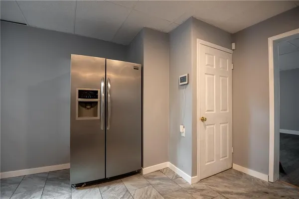 a view of a refrigerator in kitchen and a refrigerator a sink