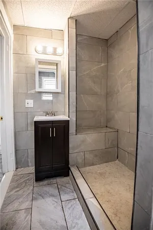a bathroom with a granite countertop sink a toilet and mirror