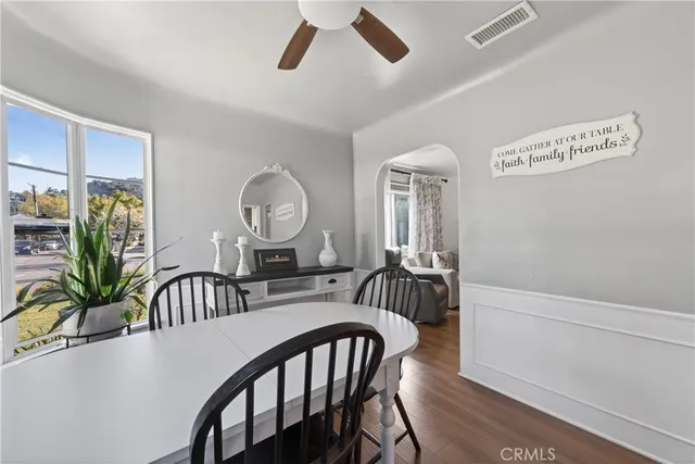 a view of a dining room with furniture and a chandelier