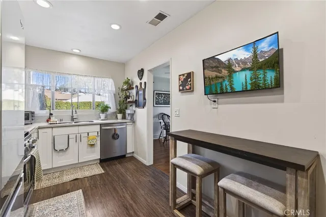 a kitchen with a sink appliances cabinets and furniture