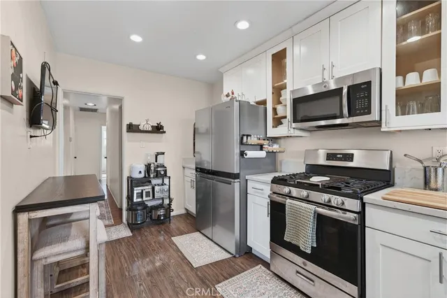 a kitchen with stainless steel appliances a refrigerator stove and microwave