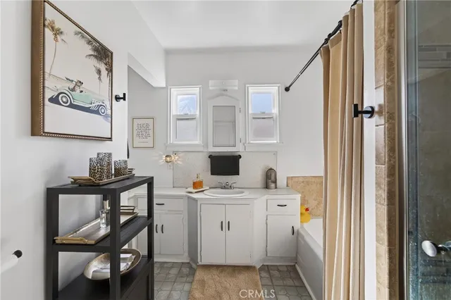 a view of a bathroom with dual sinks