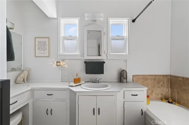 a bathroom with a sink and a mirror