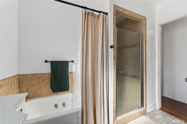 a bathroom with a bathtub and a shower