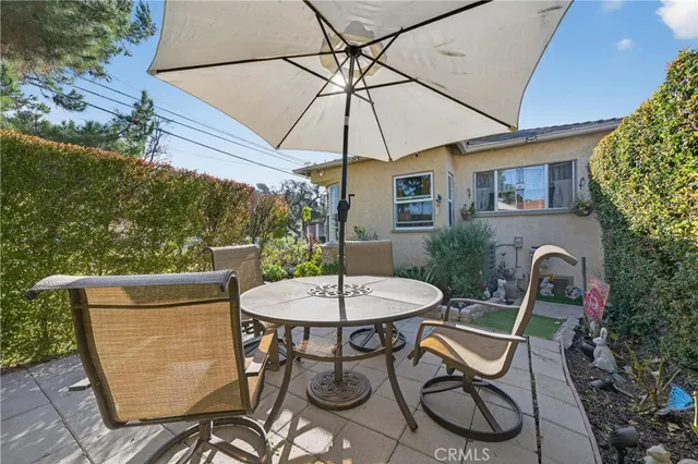 a patio table and chairs under an umbrella