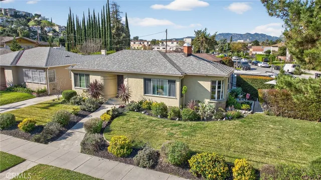 a front view of a house with garden