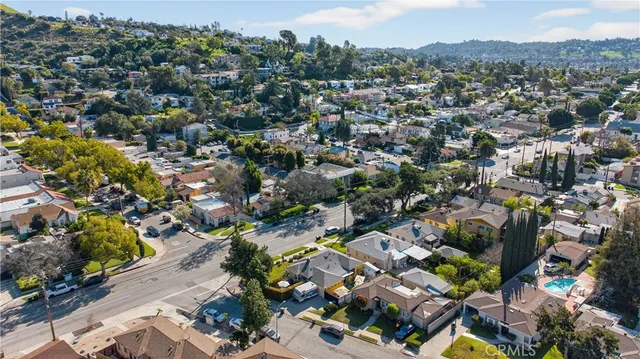 an aerial view of residential houses with outdoor space