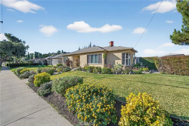 a front view of a house with a garden