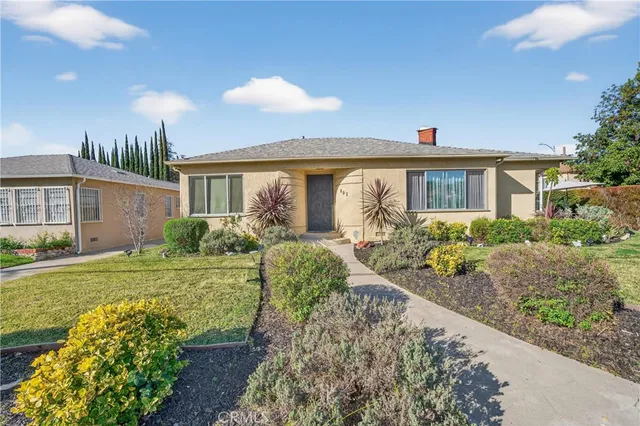 a front view of a house with garden