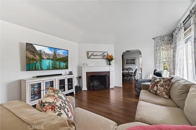 a living room with furniture fireplace and flat screen tv