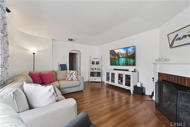 a living room with fireplace furniture and a flat screen tv