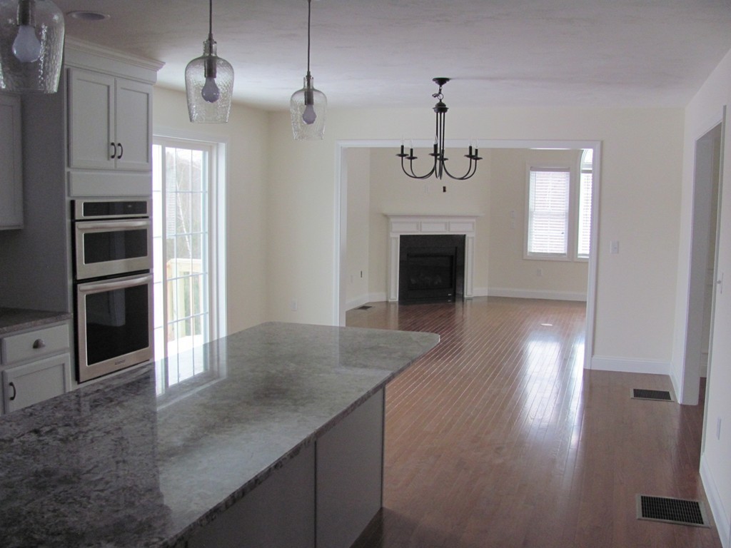 8 Harbor Trace Road Townsend, MA 01469 - Photo 4 of 17 wooden floor fireplace and windows in an empty room