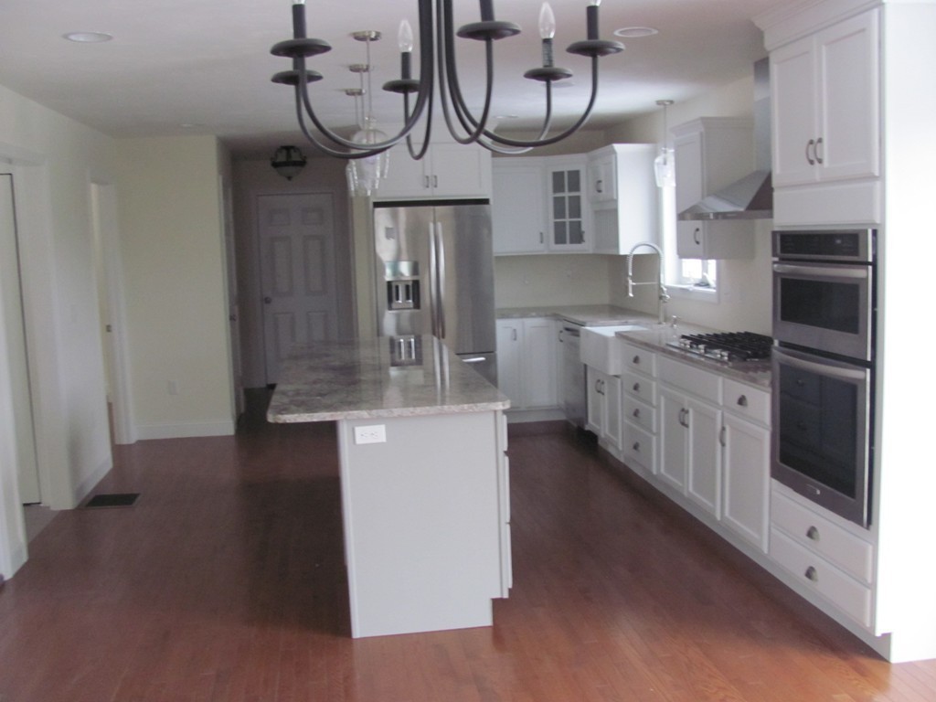 8 Harbor Trace Road Townsend, MA 01469 - Photo 5 of 17 a kitchen with cabinets a sink and a stove