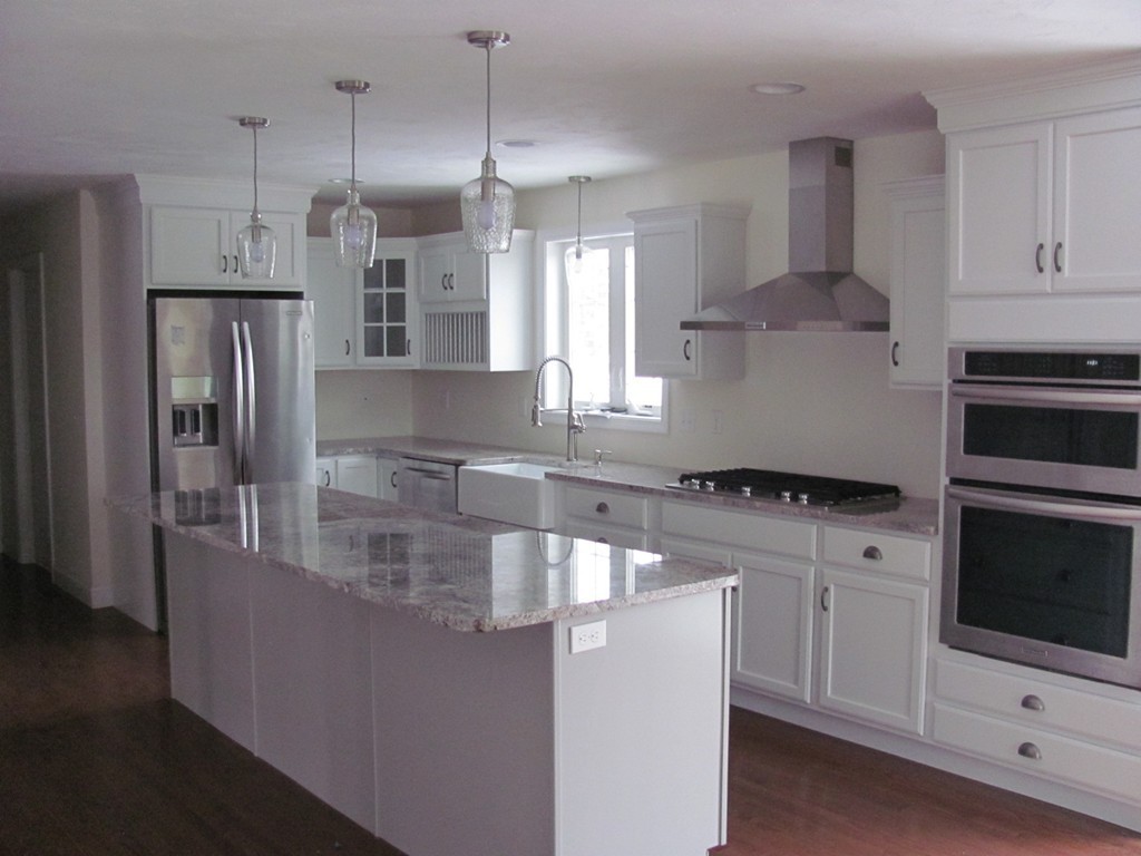 8 Harbor Trace Road Townsend, MA 01469 - Photo 6 of 17 a kitchen with stainless steel appliances granite countertop a sink a stove and a refrigerator