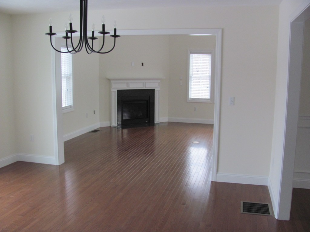 8 Harbor Trace Road Townsend, MA 01469 - Photo 8 of 17 a view of an empty room with wooden floor and a window