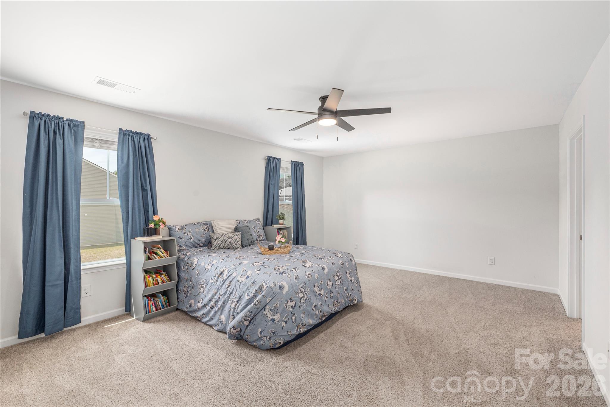 8 Madelyn Drive Clyde, NC 28721 - Photo 20 of 43 a bedroom with a bed and a chandelier