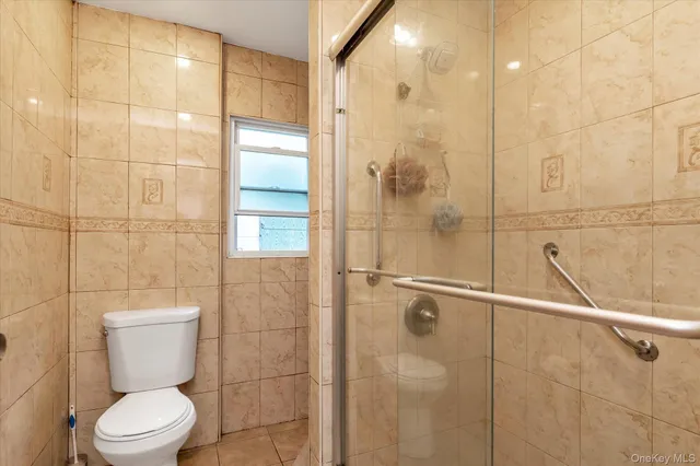 a bathroom with a toilet and shower