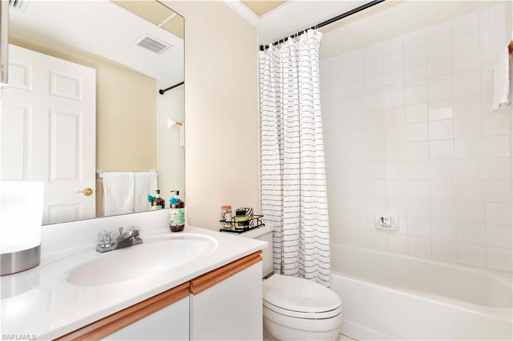 835 Tanbark Drive, Unit 203 Naples, FL 34108 - Photo 14 of 17 a bathroom with a sink a toilet and shower
