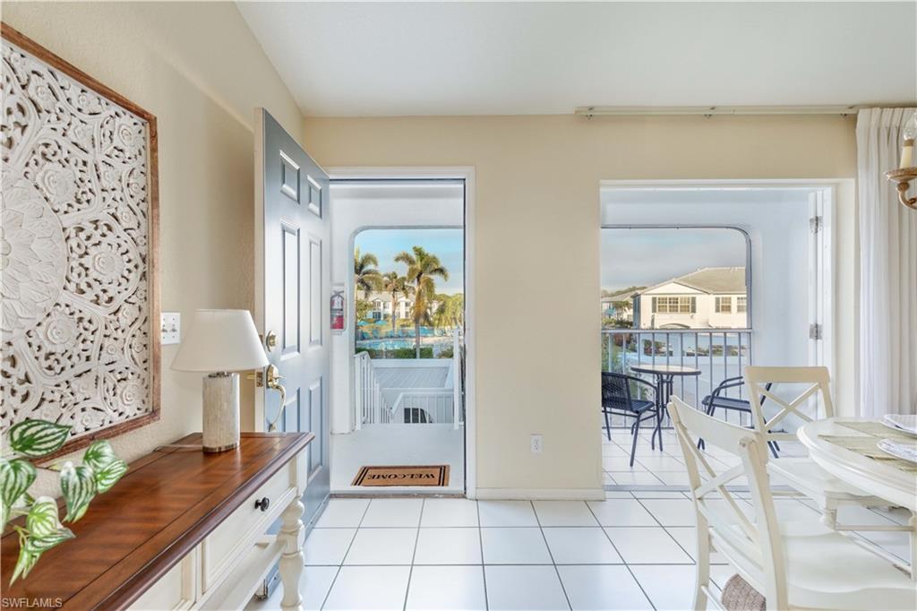 835 Tanbark Drive, Unit 203 Naples, FL 34108 - Photo 3 of 17 a living room with furniture and a table
