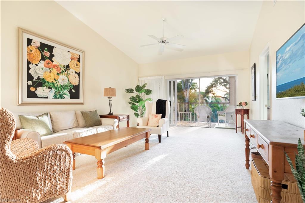 835 Tanbark Drive, Unit 203 Naples, FL 34108 - Photo 7 of 17 a living room with furniture and a large window
