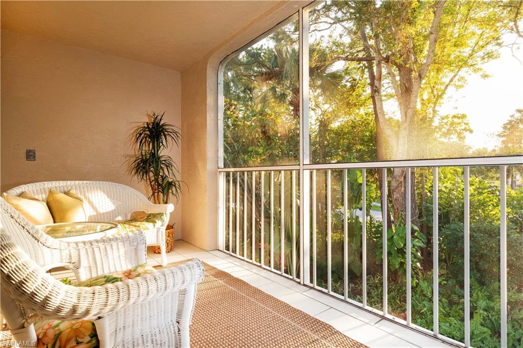 835 Tanbark Drive, Unit 203 Naples, FL 34108 - Photo 8 of 17 a view of a balcony with furniture