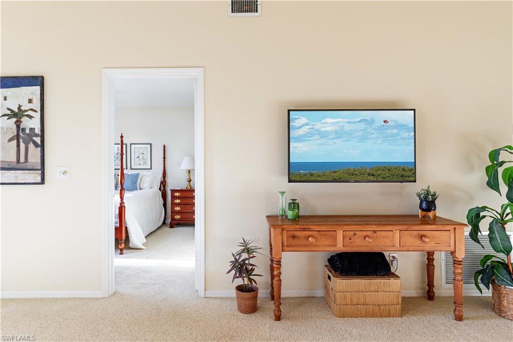 835 Tanbark Drive, Unit 203 Naples, FL 34108 - Photo 10 of 17 a living room with furniture and a fireplace