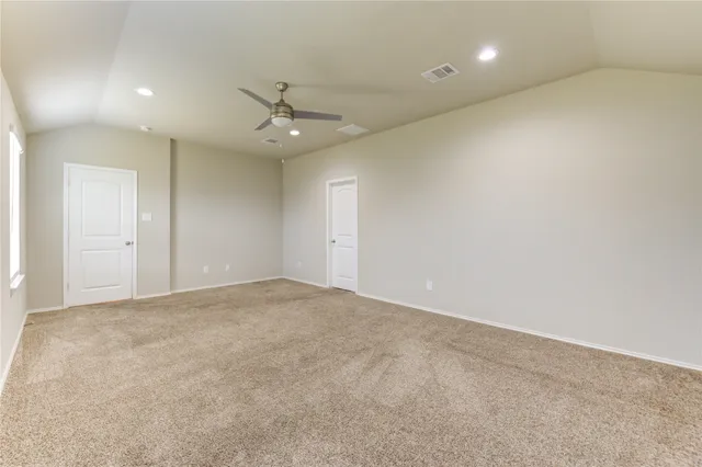 an empty room with fan and a ceiling fan