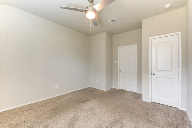 a view of a livingroom with a ceiling fan and window