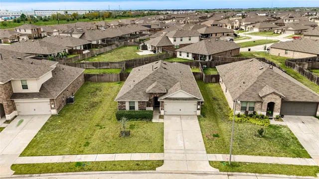 an aerial view of residential houses with outdoor space