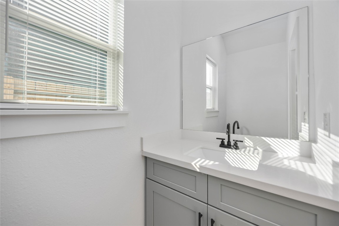 7710 Independence Street, Unit A Houston, TX 77051 - Photo 11 of 25 a bathroom with a sink and a mirror