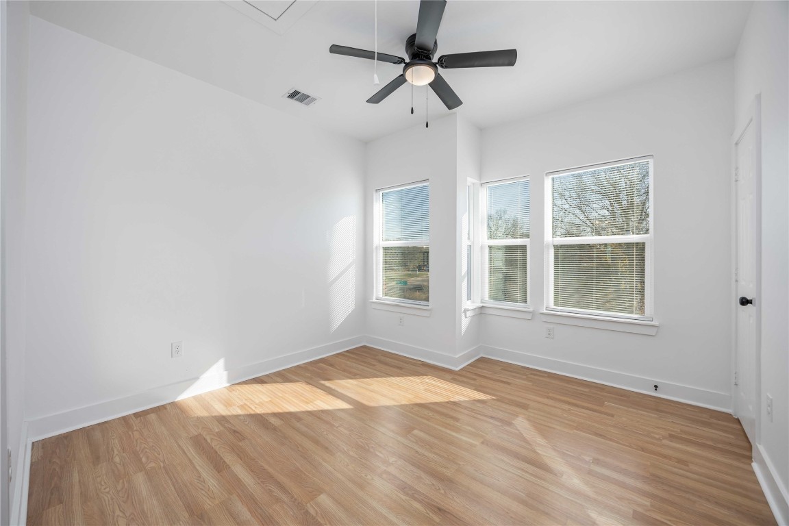 7710 Independence Street, Unit A Houston, TX 77051 - Photo 14 of 25 a view of empty room with wooden floor and fan