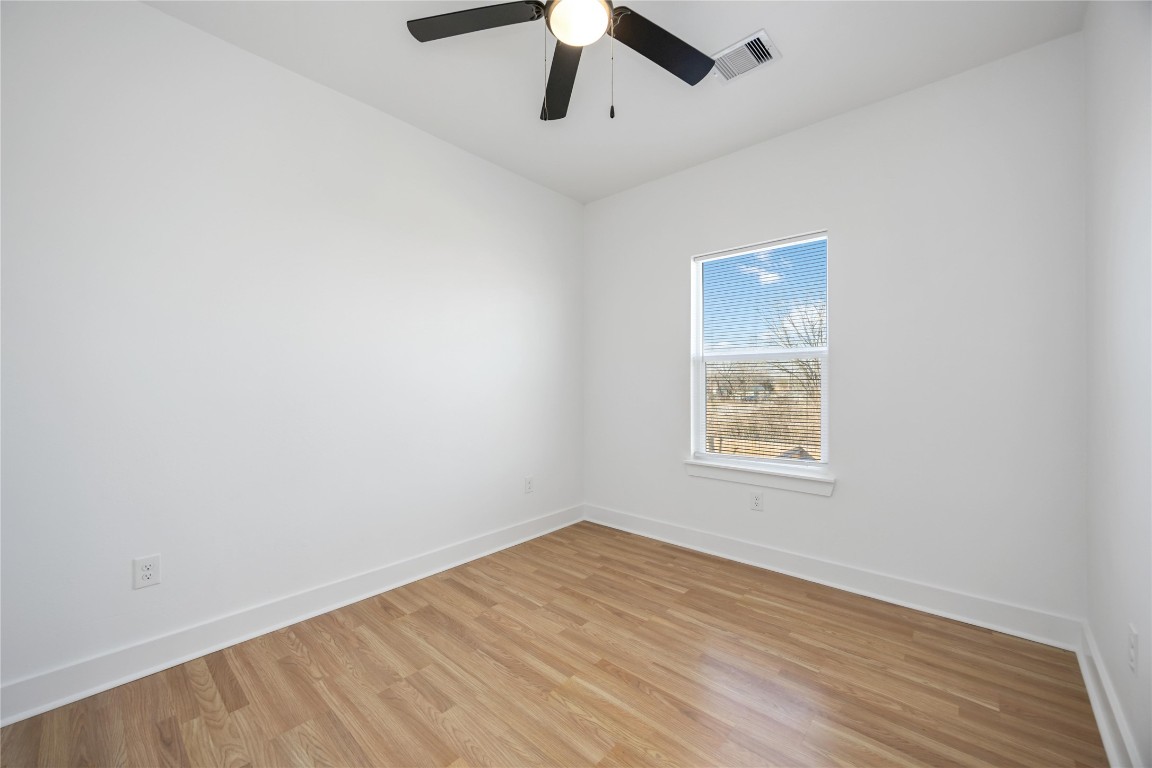 7710 Independence Street, Unit A Houston, TX 77051 - Photo 19 of 25 an empty room with a window and a ceiling fan