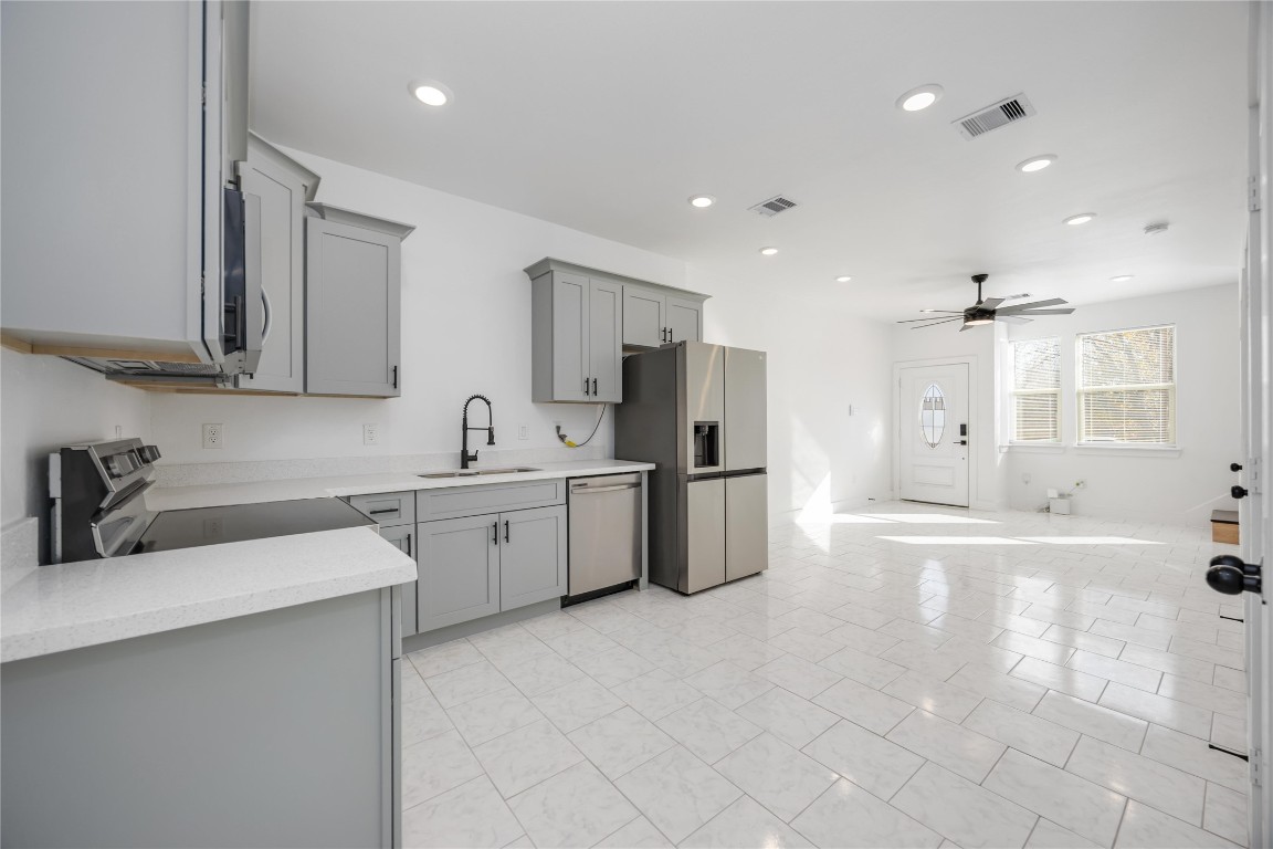 7710 Independence Street, Unit A Houston, TX 77051 - Photo 9 of 25 a view of a kitchen with a sink a refrigerator and window