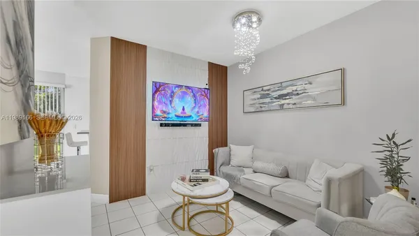 a living room with furniture and a chandelier