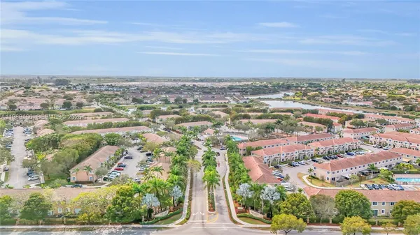 an aerial view of residential building and trees around