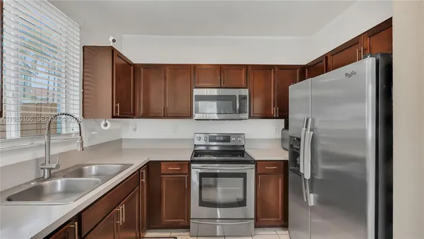 a kitchen with a sink stove and refrigerator