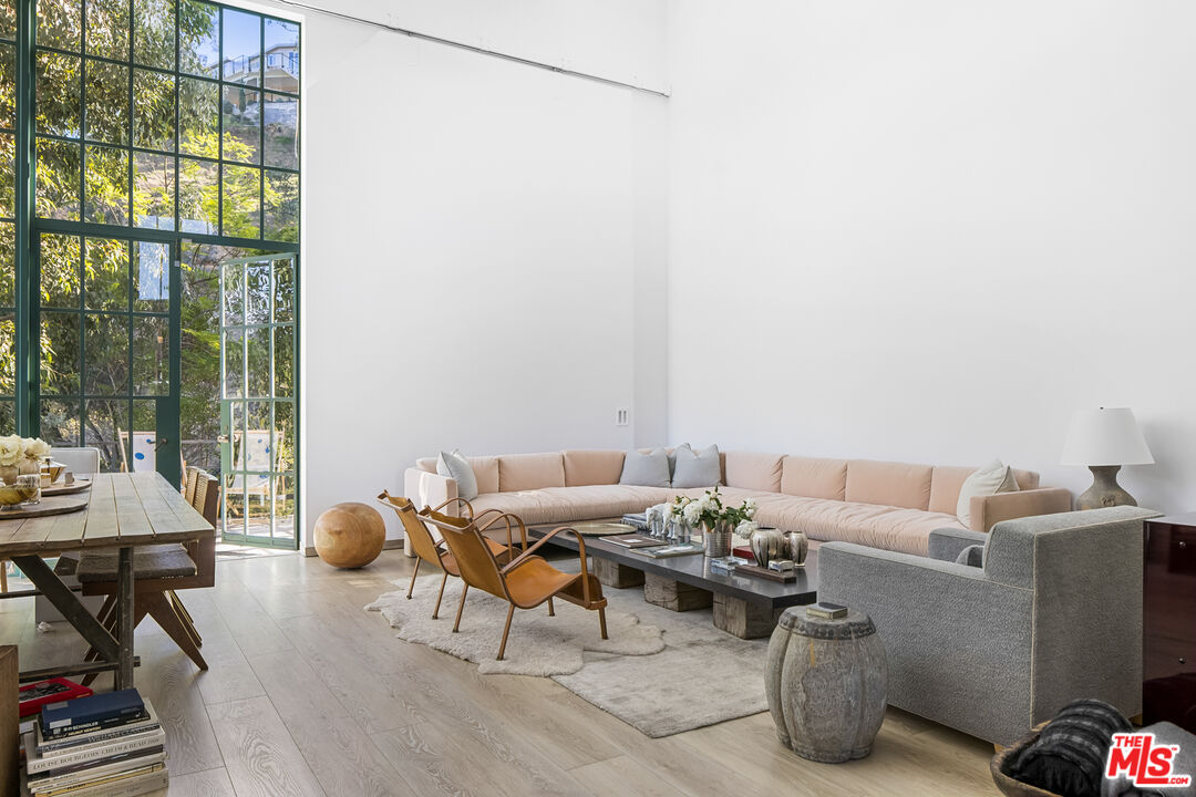 2456 Astral Drive Los Angeles, CA 90046 - Photo 16 of 33 a living room with furniture and a floor to ceiling window