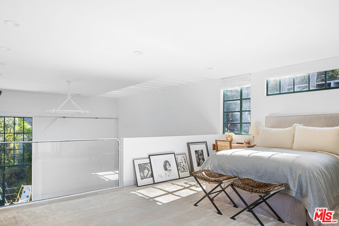 2456 Astral Drive Los Angeles, CA 90046 - Photo 21 of 33 a bedroom with a bed and a couch