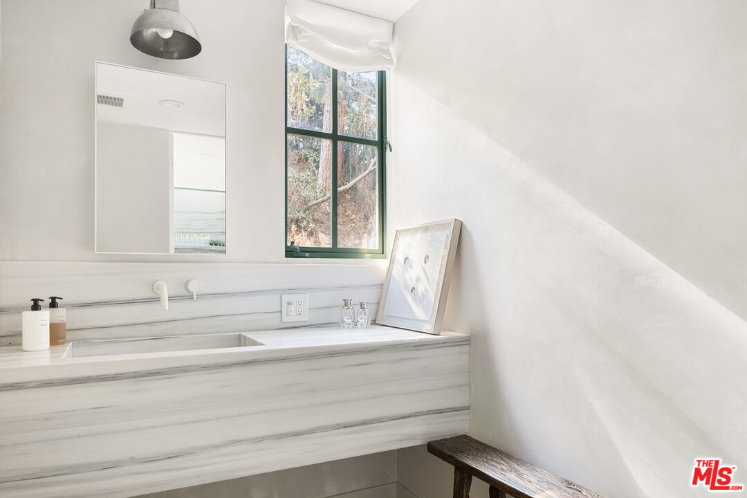 2456 Astral Drive Los Angeles, CA 90046 - Photo 23 of 33 a bathroom with a bathtub and a sink