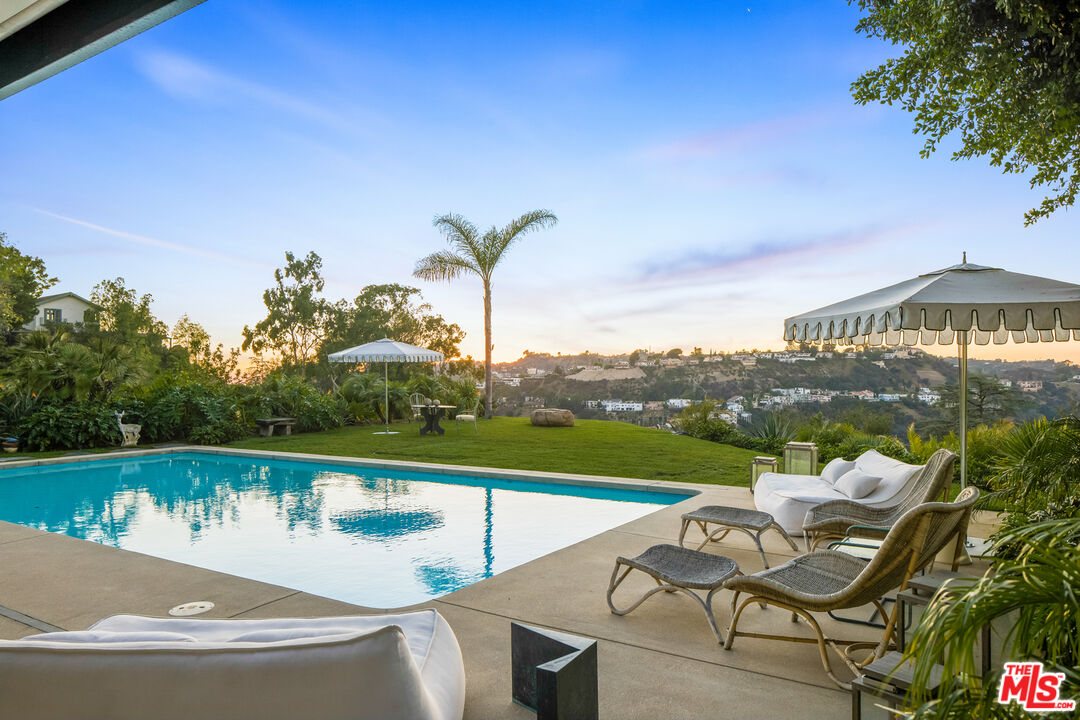 2456 Astral Drive Los Angeles, CA 90046 - Photo 25 of 33 a view of a swimming pool with a lounge chair