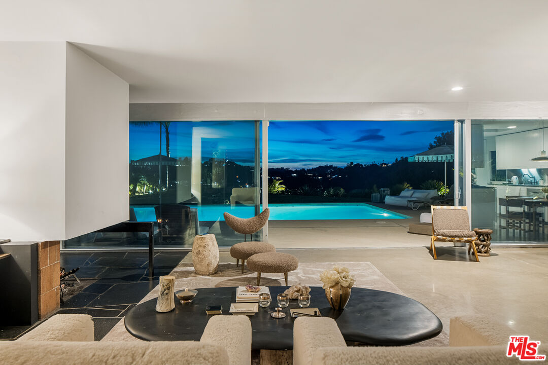 2456 Astral Drive Los Angeles, CA 90046 - Photo 31 of 33 a living room with furniture and a floor to ceiling window