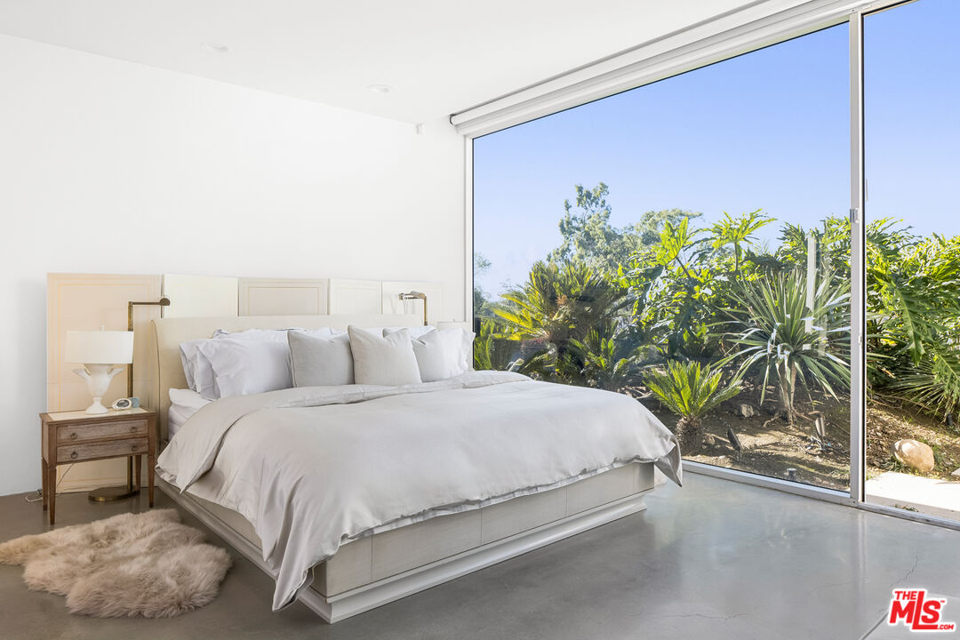 2456 Astral Drive Los Angeles, CA 90046 - Photo 7 of 33 a bedroom with a bed potted plant and a window